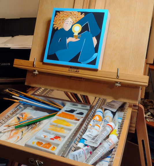 A wooden pochade box easel shows an unfinished painting of a woman contorted into an uncomfortable position in a small box. She is holding a burning candle in one hand.